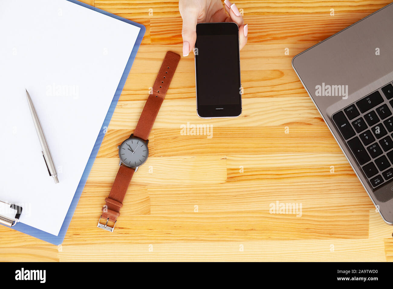 Contract. Blank of paper is on a wooden desk. Blank a4 paper is in the middle of wood office desk table with supplies. Top view with copy space, flat Stock Photo