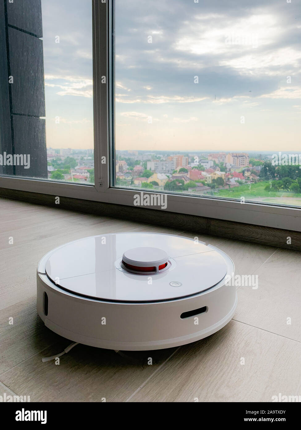 Robot vacuum cleaner cleaning on wooden 