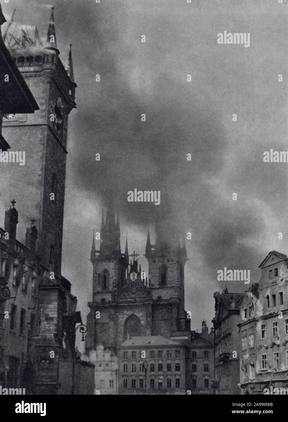 Fire on the medieval tower of the Old Town Hall (Staroměstská radnice) in Old Town Square (Staroměstské náměstí) in Prague, Czechoslovakia, during the Prague Uprising in the last days of World War II in May 1945. Black and white photograph by Czech photographer Oldřich Smola taken probably on 8 May 1945 and published in the Czechoslovak book 'The Heart of Prague on Fire' ('Srdce Prahy v plamenech') issued in 1946. Courtesy of the Azoor Postcard Collection. Stock Photo