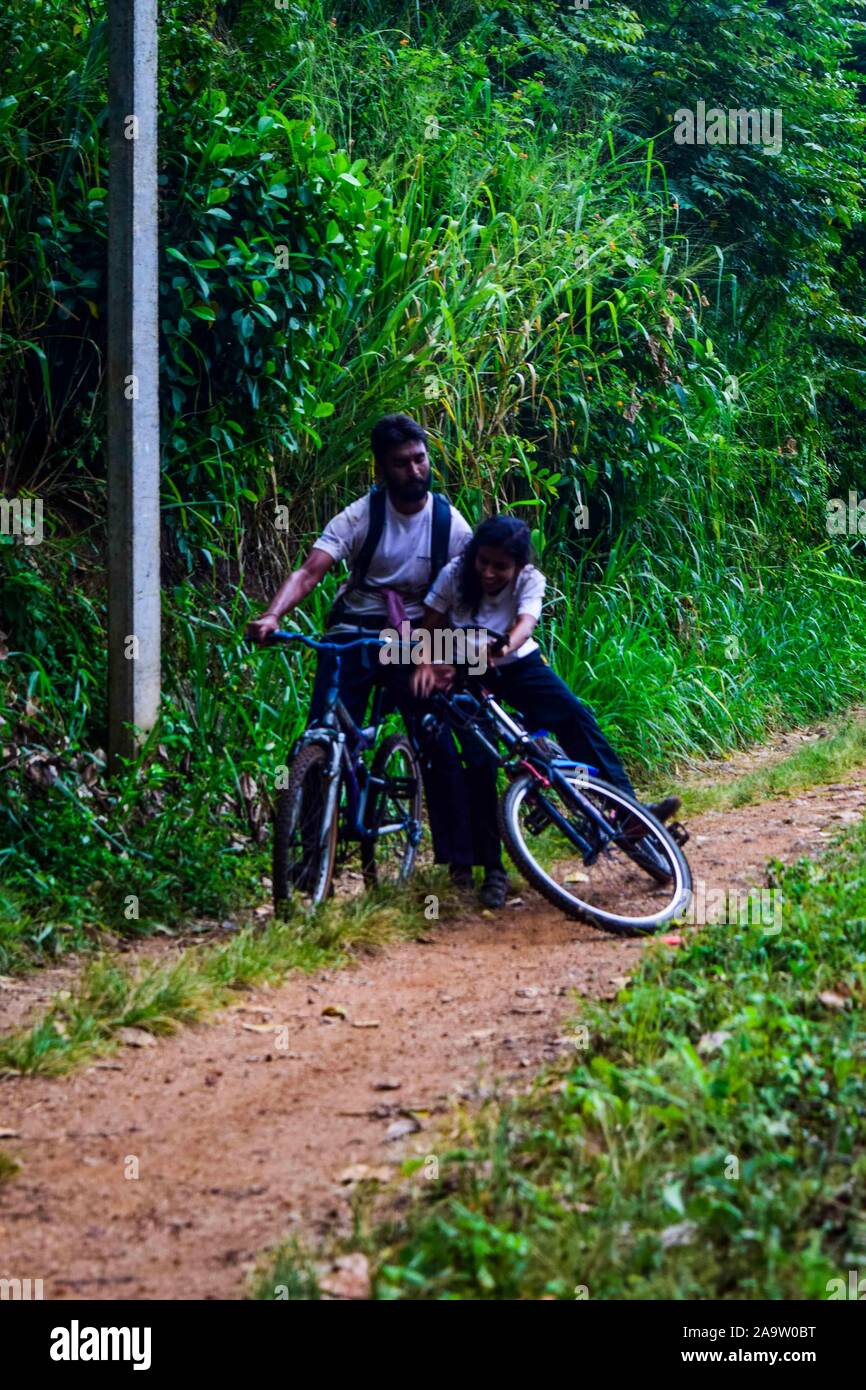 May. 2018 , Kandy , Sri Lanka , Young boy and girl funny bicycle accident Stock Photo