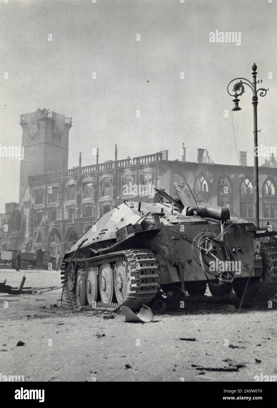 Wrecked German light tank destroyer Jagdpanzer 38 Hetzer in front of the ruins of the Old Town Hall (Staroměstská radnice) in Old Town Square (Staroměstské náměstí) in Prague, Czechoslovakia, damaged and burnt during the Prague Uprising in the last days of World War II in May 1945. Black and white photograph by Czech photographer Oldřich Smola taken probably on 9 May 1945 and published in the Czechoslovak book 'The Heart of Prague on Fire' ('Srdce Prahy v plamenech') issued in 1946. Courtesy of the Azoor Postcard Collection. Stock Photo