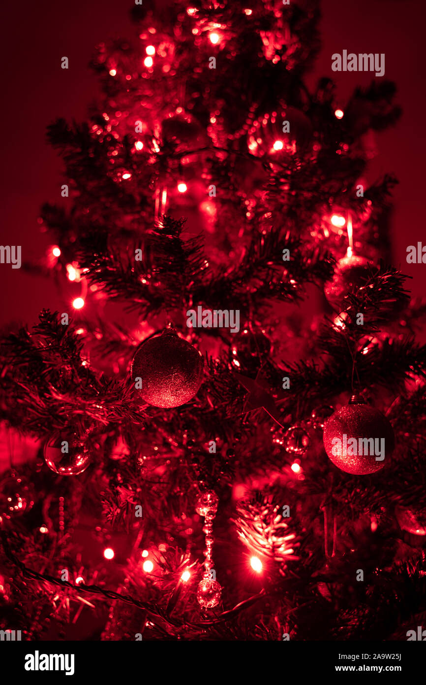 Christmas tree with red lights. Shiny christmas ornaments are