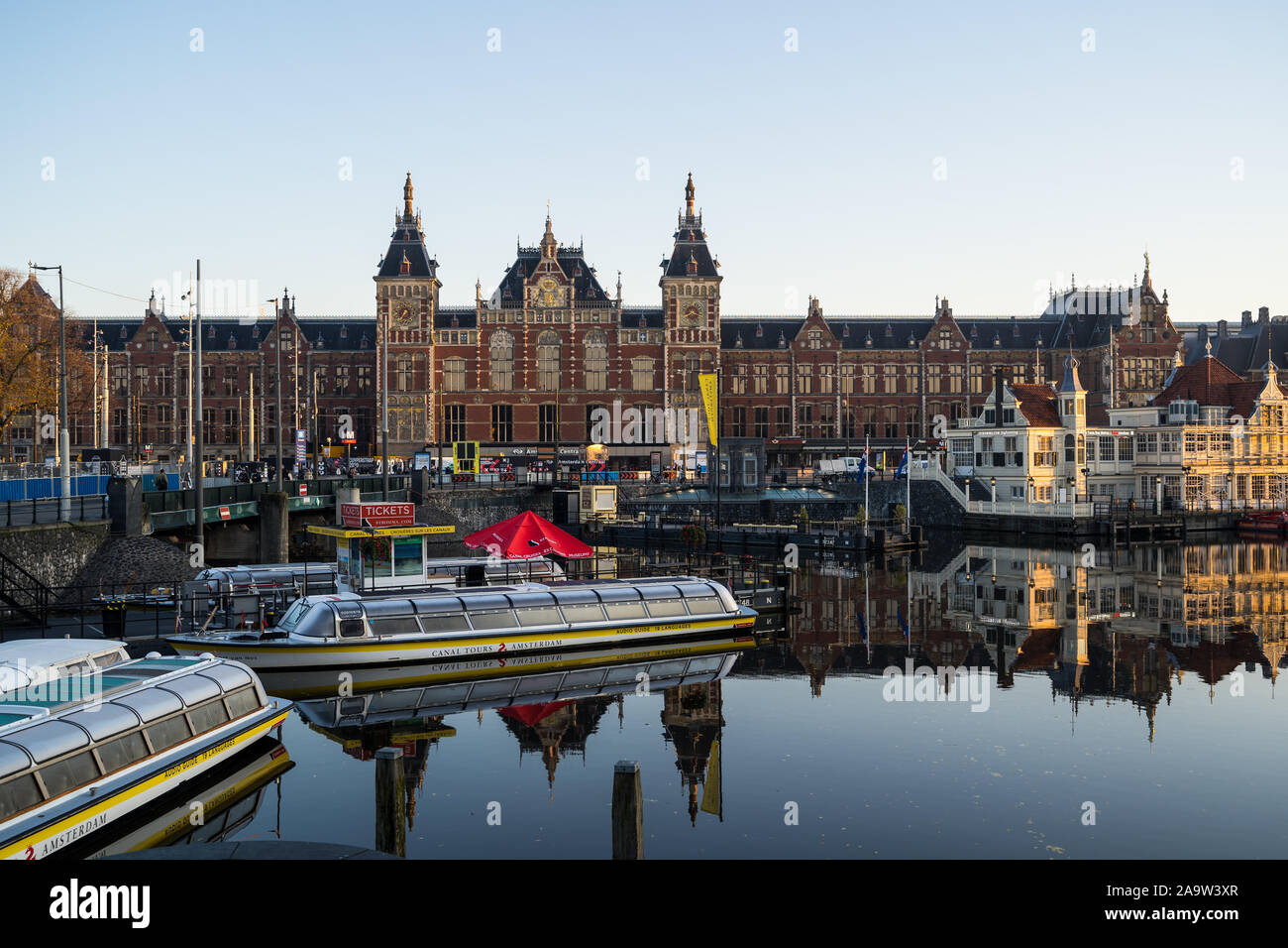 Amsterdam, Netherlands - November 9, 2019: House boats and tourist boats along Signel canal during an early autumn fall morning outside of Amsterdam C Stock Photo