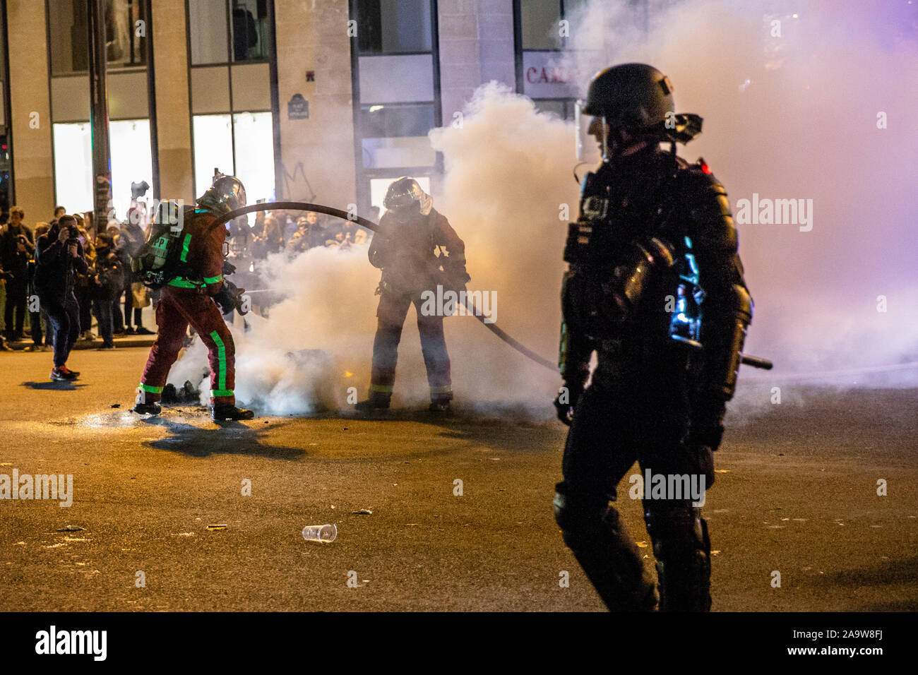 Paris, France. 17th Nov, 2019. French police forces disperse demonstrators during a demonstration to mark the first anniversary of the Yellow Vests movement in Paris, France, on Nov. 17, 2019. On Nov. 17, 2018, the movement, which got its name from the high visibility vests drivers keep in their cars, started as a campaign against an increase in diesel's price, most commonly used car fuel in France, that Macron said is necessary to combat climate change. Credit: Aurelien Morissard/Xinhua/Alamy Live News Stock Photo
