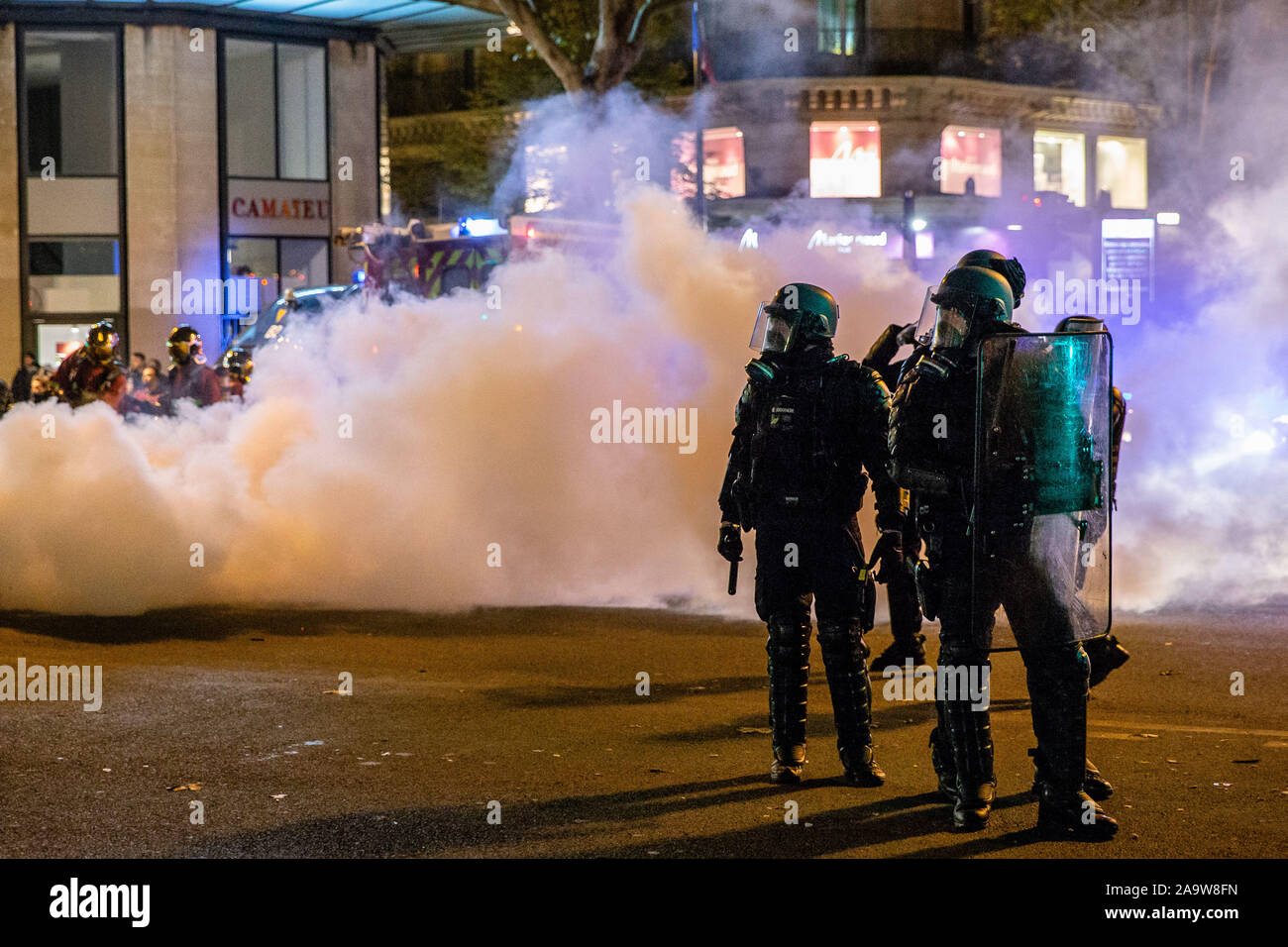 Paris, France. 17th Nov, 2019. French police forces disperse demonstrators during a demonstration to mark the first anniversary of the Yellow Vests movement in Paris, France, on Nov. 17, 2019. On Nov. 17, 2018, the movement, which got its name from the high visibility vests drivers keep in their cars, started as a campaign against an increase in diesel's price, most commonly used car fuel in France, that Macron said is necessary to combat climate change. Credit: Aurelien Morissard/Xinhua/Alamy Live News Stock Photo