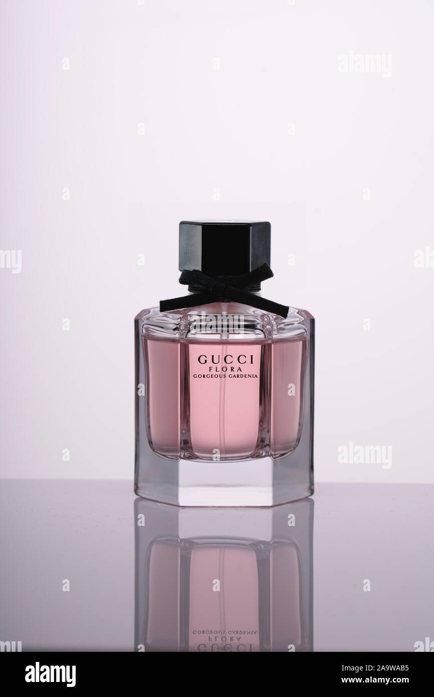 Italy, Milan - 15 November 2019: Perfume glass bottle of Flora Gorgeous  Gardenia by Gucci on white background on a mirror surface with reflection  on table. Studio photography Stock Photo - Alamy