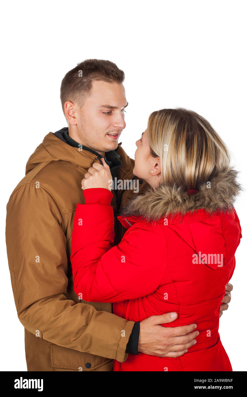 Young couple wearing red and brown winter parka jacket posing on isolated  background - Seasonal fashion clothing Stock Photo - Alamy