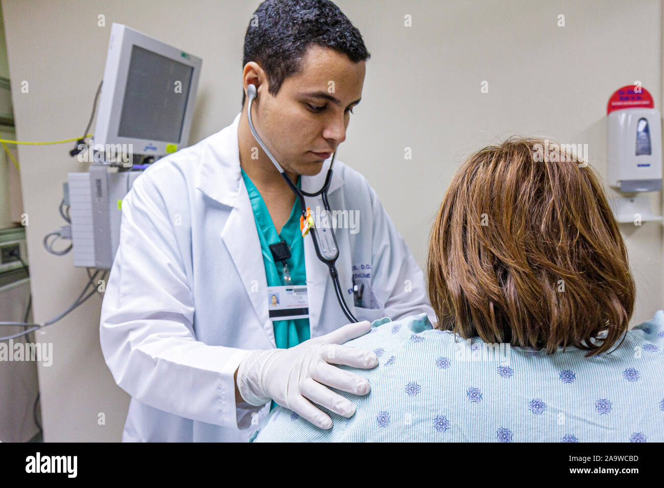 Miami Beach Florida,Mt. Mount Sinai Medical Center,hospital,healthcare,emergency room,patient,doctor,Hispanic man men male,stethoscope,listening,FL100 Stock Photo