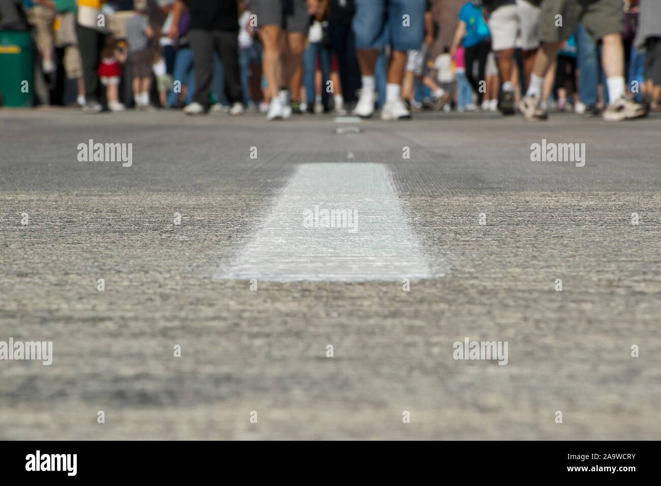 A large group of people approach on a road closed to traffic Stock ...