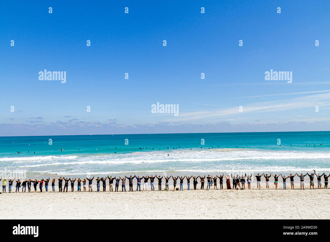 Miami Beach Florida,Surfrider Foundation,No Offshore Florida Oil Drilling Protest,Black clothing represents oil,hold hand,hands,unity,Atlantic Ocean,w Stock Photo