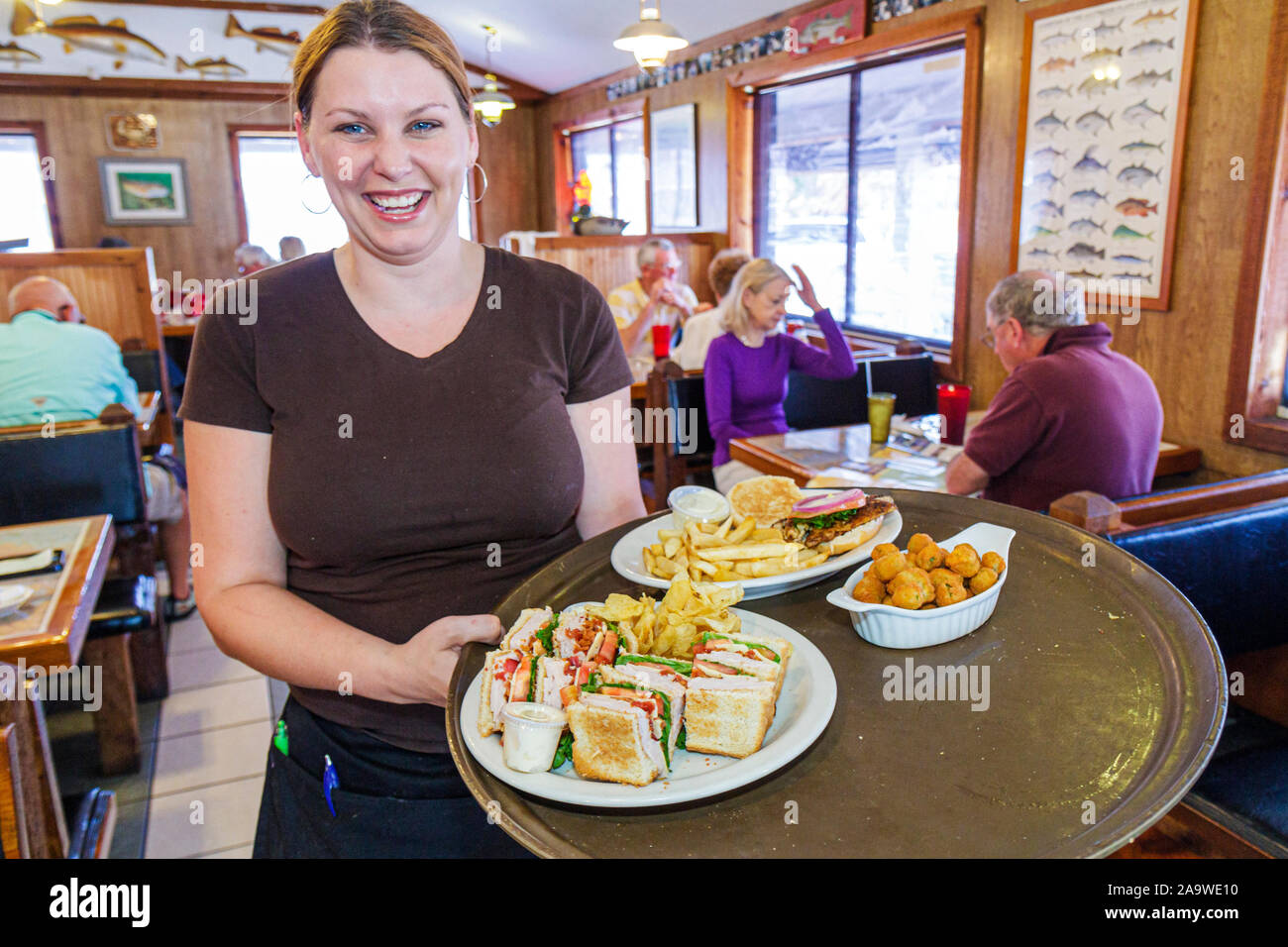 Florida The Everglades,Everglades City,waitress server employee worker workers working staff,serving food,tray,service,FL100322024 Stock Photo