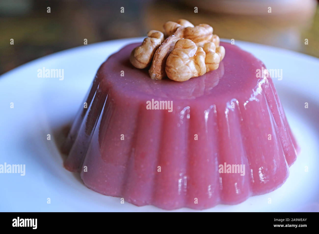 Closeup Pelamushi Topped with Walnut, Georgian National Sweets Served on White Plate Stock Photo