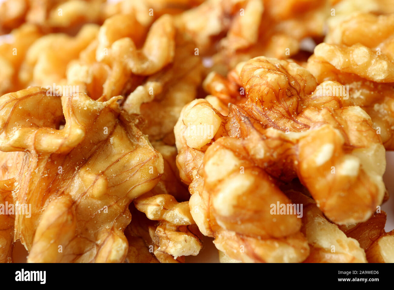 Closeup Texture of Walnut Kernels on the Pile of Raw Walnuts Stock Photo