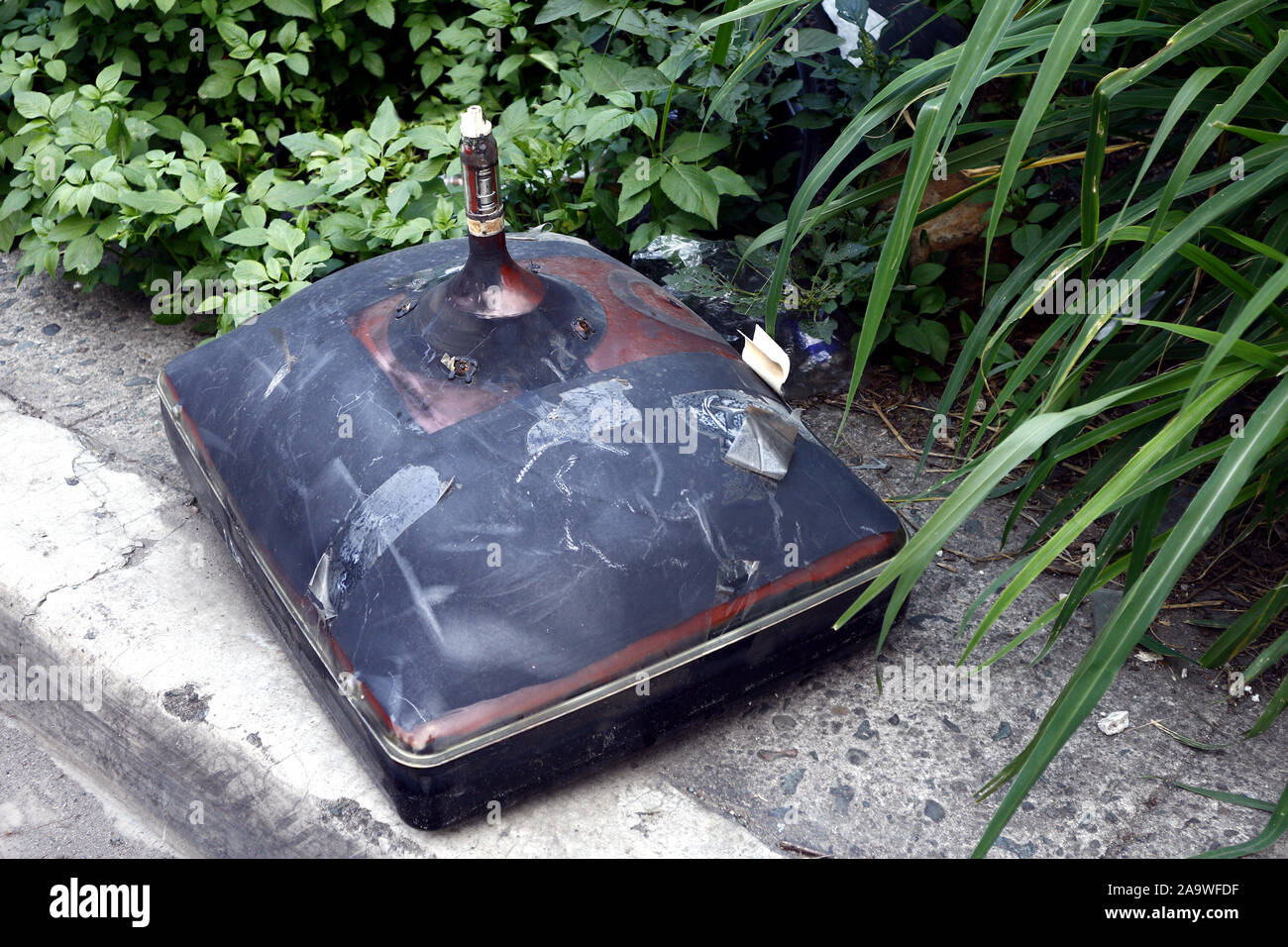 Photo of old and broken television with picture tube on a sidewalk