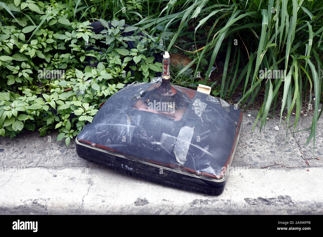 Photo of old and broken television with picture tube on a sidewalk
