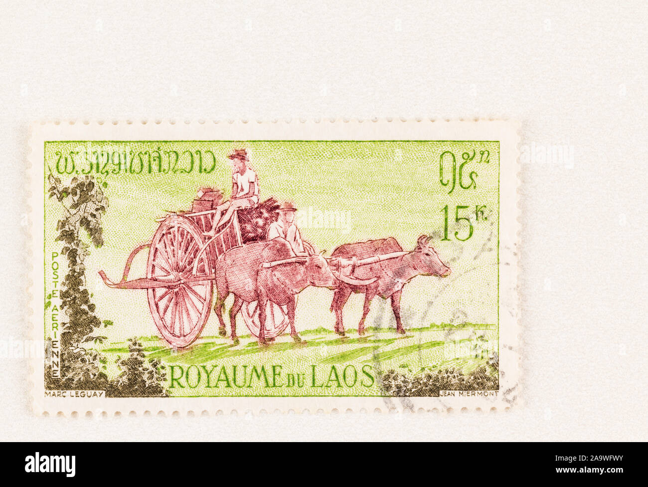 SEATTLE WASHINGTON - October 5, 2019: Man and youth with buffalo drawn 2 wheeled cart travelling through countryside. Green and brown used stamp issue Stock Photo