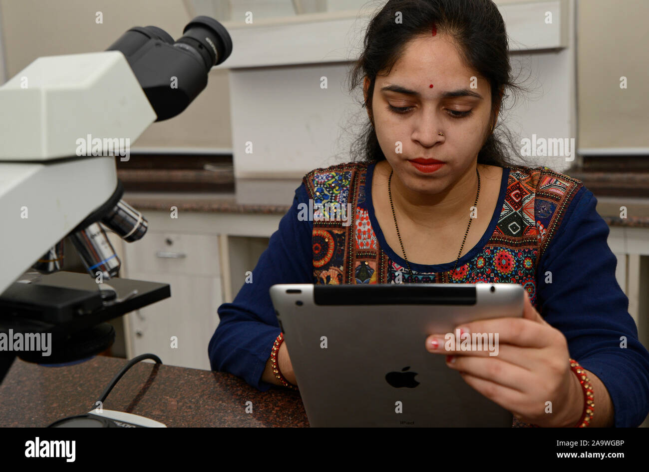 Woman using tablet in a laboratory, Concept science and Technology Stock Photo