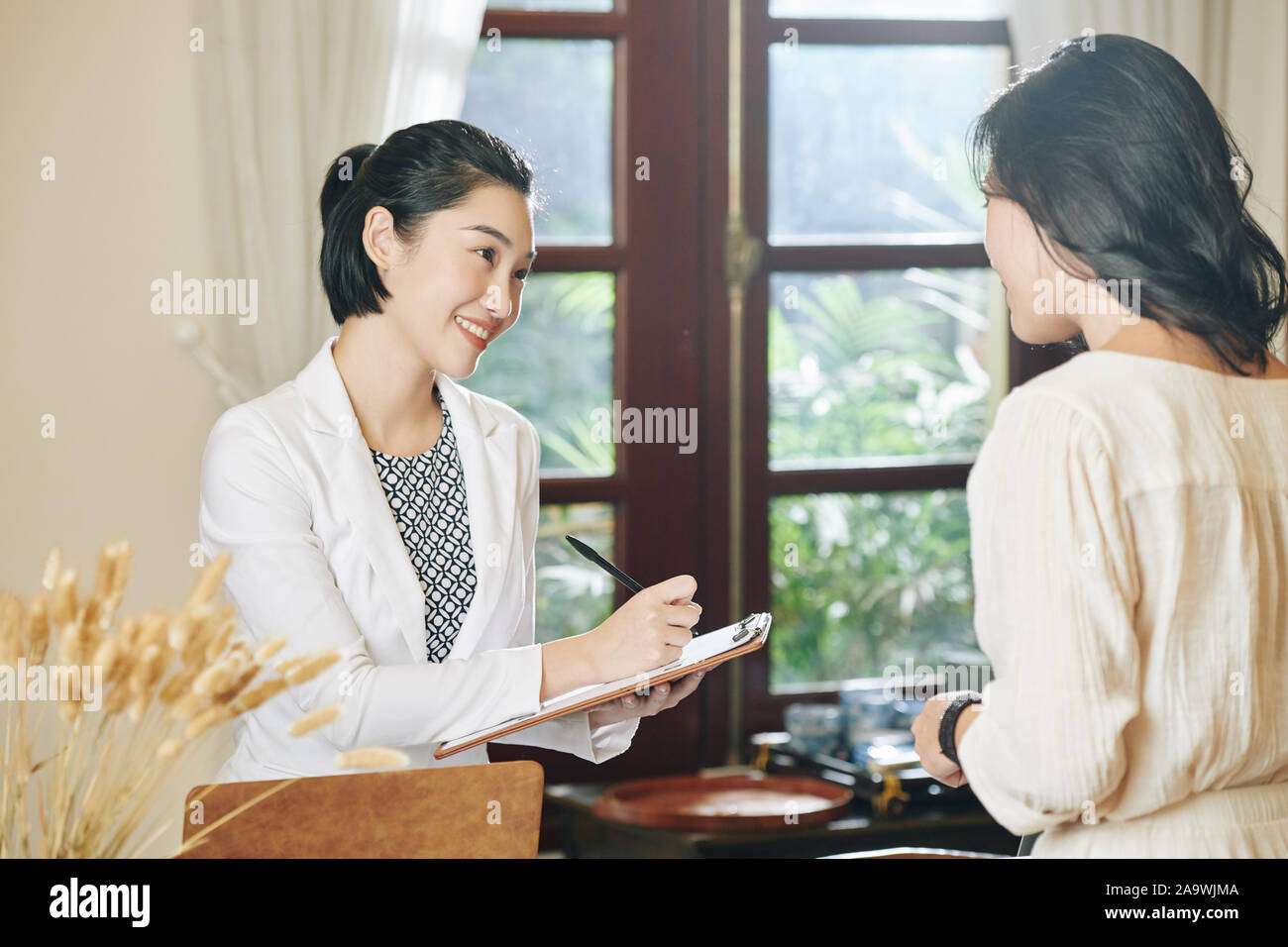 receptionist salon spa pretty writing female alamy beauty vietnamese smiling down