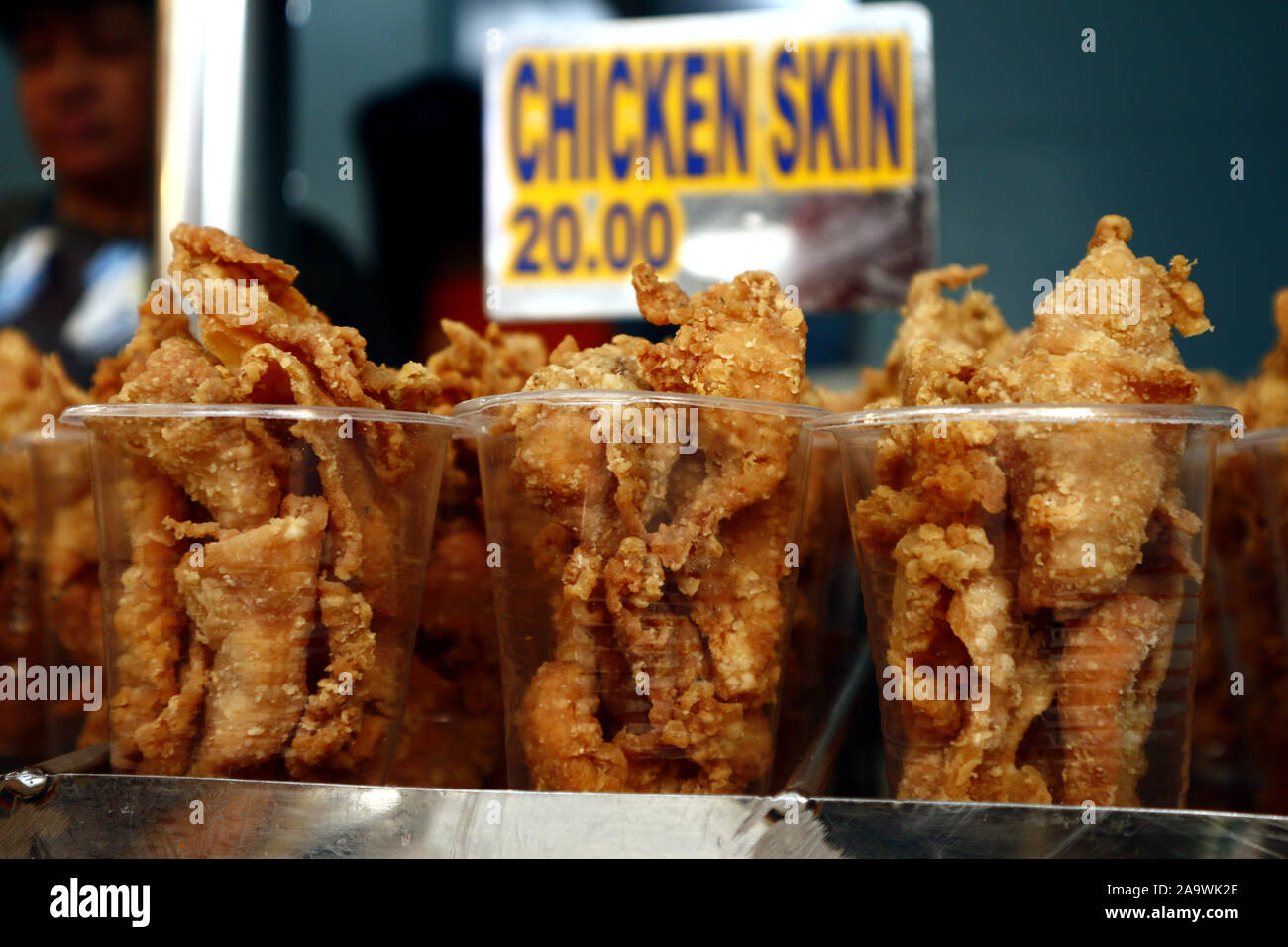 Photo of freshly deep fried chicken skin on display at a store Stock