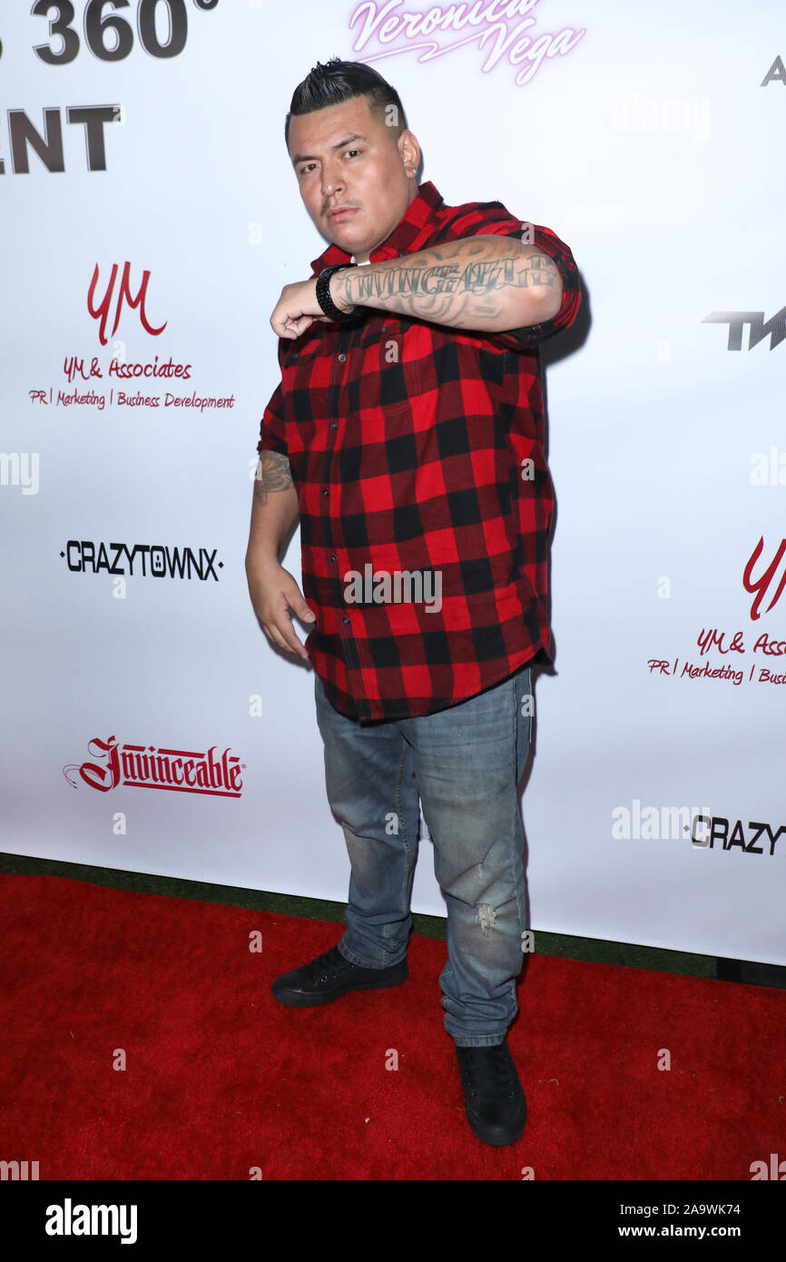 Los Angeles, California, USA. 14th November, 2019. Rapper 'Invinceable',  shows his arm with the tattoo of his name at the Academy LA in Hollywood,  California on November 14, 2019. Credit: Sheri Determan/Alamy.com, image size:866x1390
