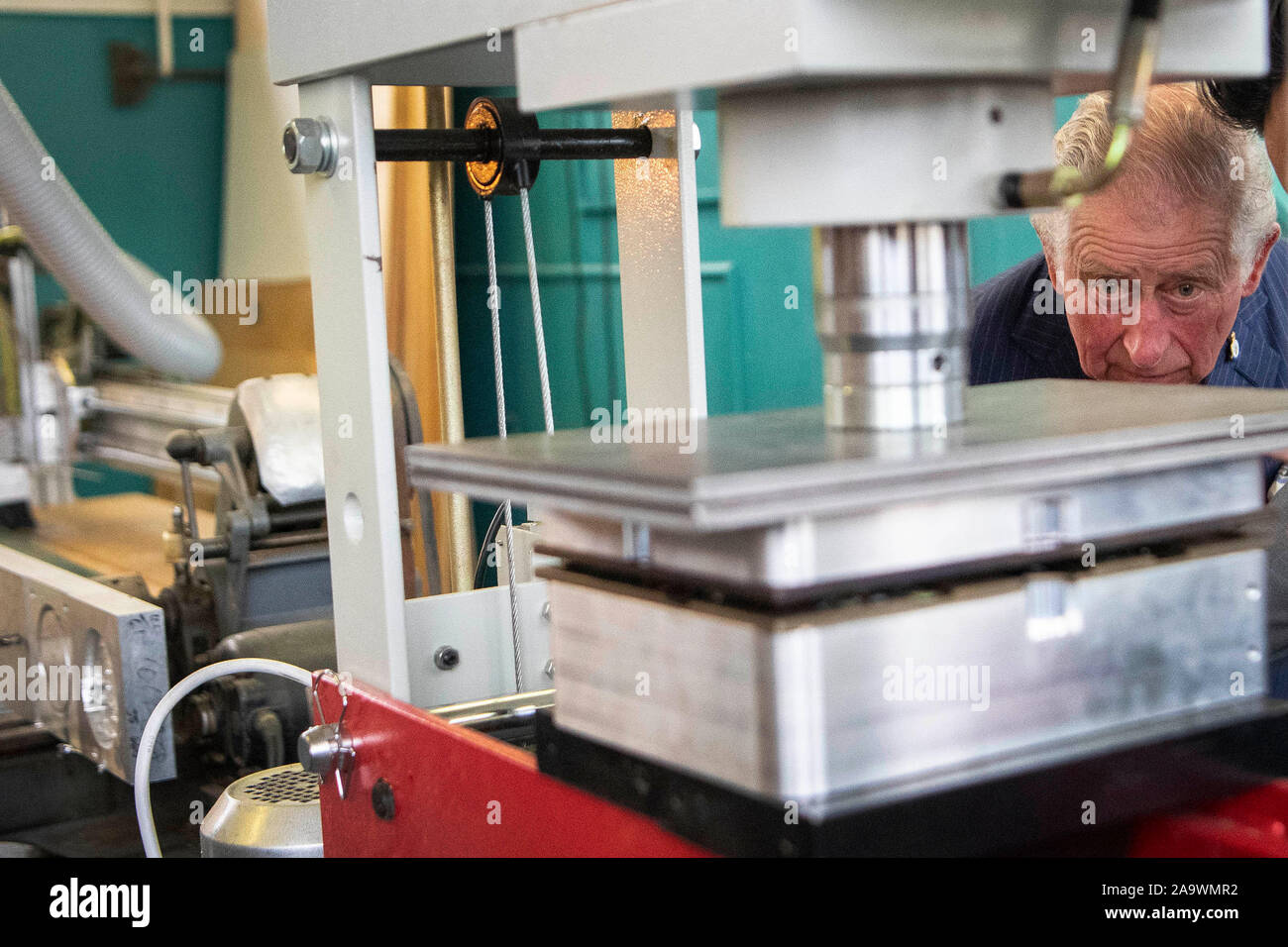 The Prince of Wales looks at the manufacturing process of products made out of plastic waste