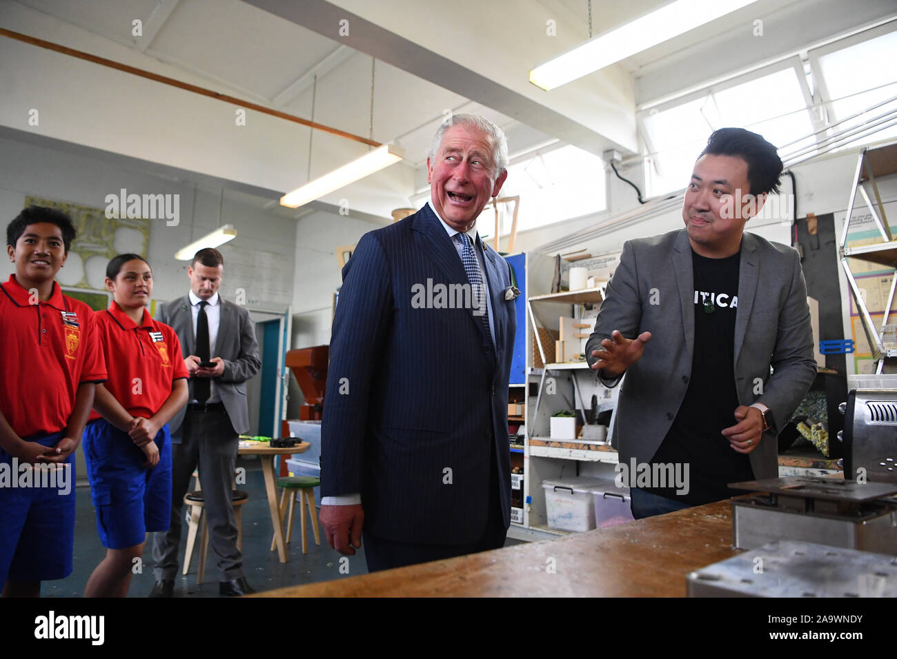 The Prince of Wales looks at the manufacturing process of products made out of plastic waste, during a visit to Critical Design, an Auckland based company that manufactures a range of office and homeware products from recycled materials, at Wesley Intermediate School in Auckland on the second day of the royal visit to New Zealand. Stock Photo
