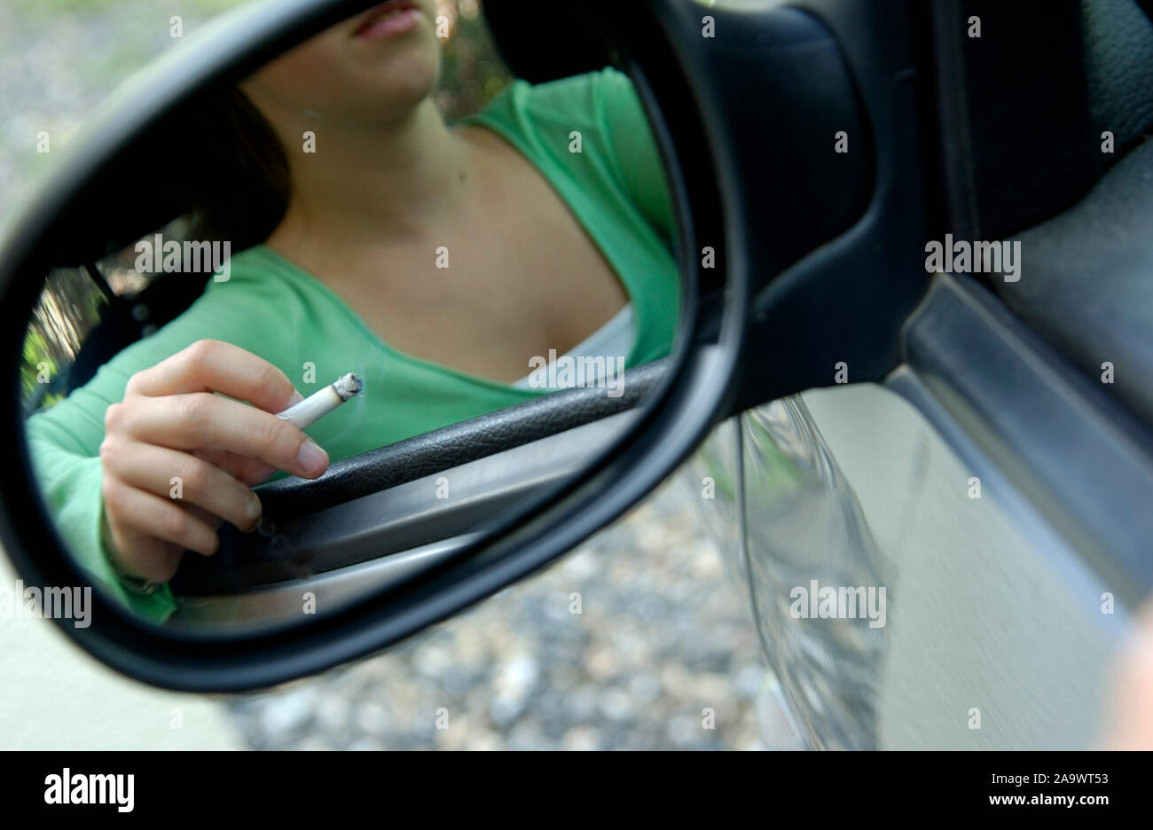 .Smoking teenager in a car Stock Photo