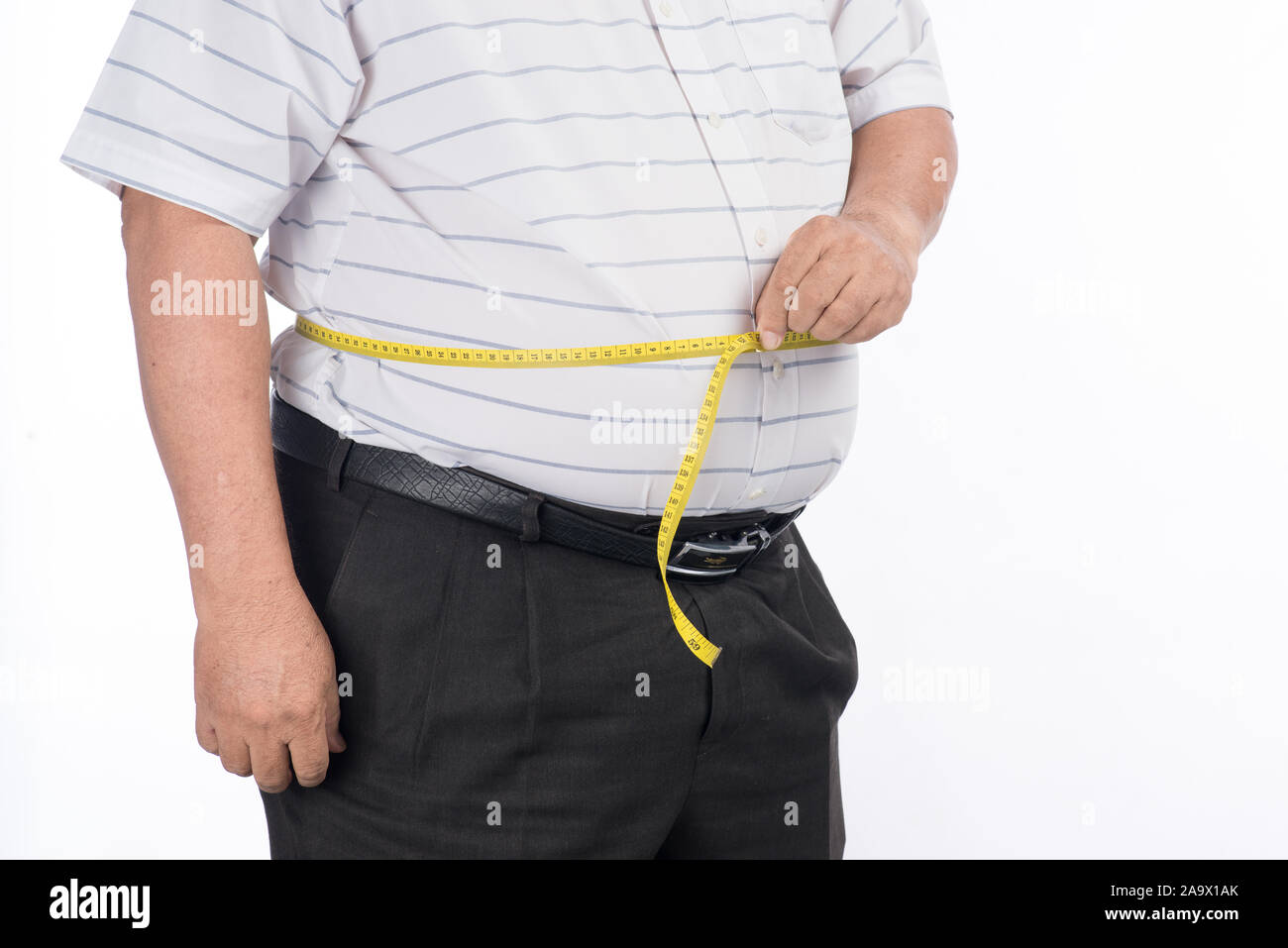 Fat mature man measuring his belly with measurement tape, isolated on white background Stock Photo