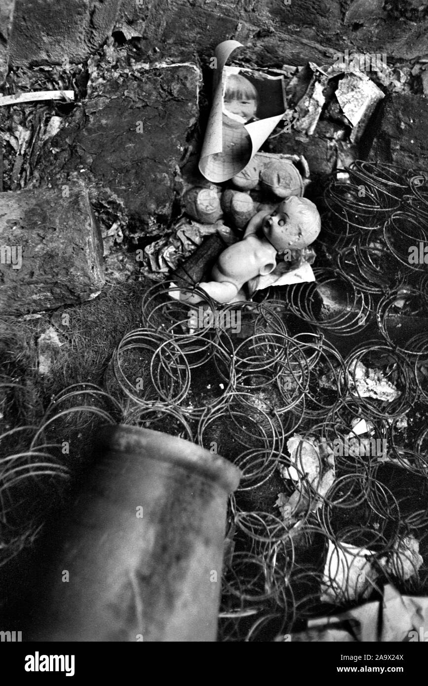 Broken dolls body parts discarded dolls hospital in abandoned slum clearance house London UK 1960s. 1967 HOMER SYKES Stock Photo