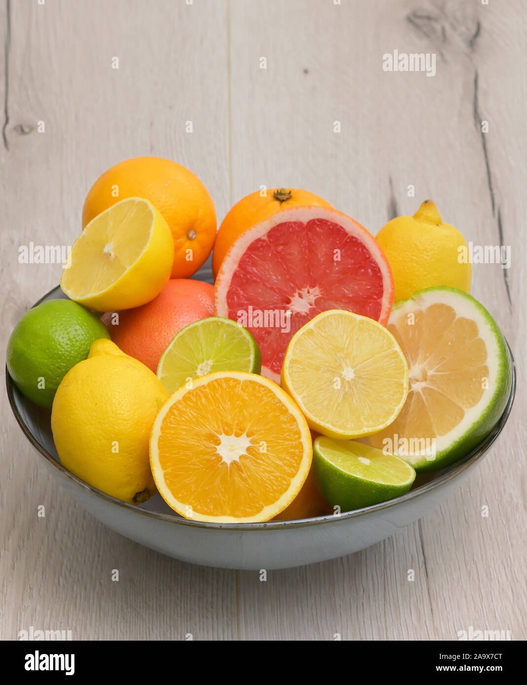 Colorful Assortment Of Citrus Fruit on Wooden Table Stock Photo