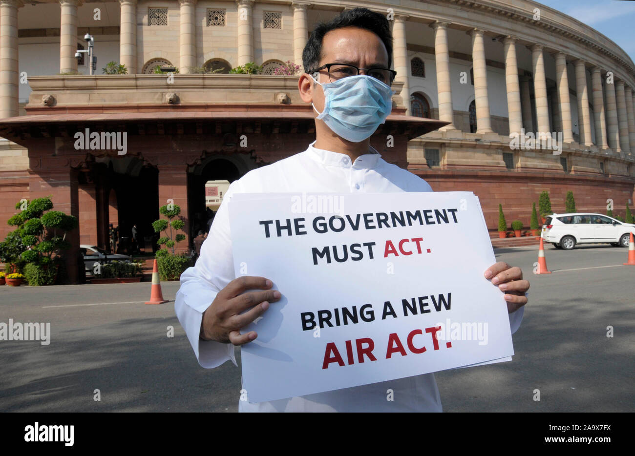Congress Party MP Gaurav Gogoi holds placards protesting against the alarming levels of pollution in the city on the opening day of the winter session Stock Photo