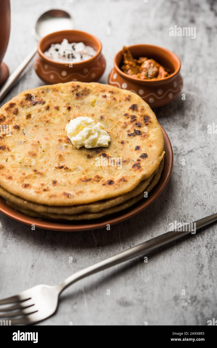 Aloo Paratha / Indian Potato stuffed Flatbread with butter on top. Served with fresh sweet Lassi