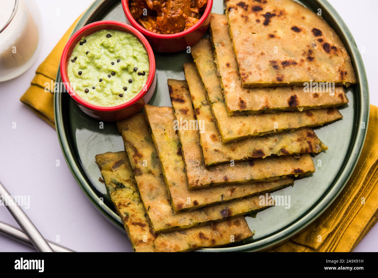 Aloo Paratha / Indian Potato stuffed Flatbread with butter on top. Served with fresh sweet Lassi
