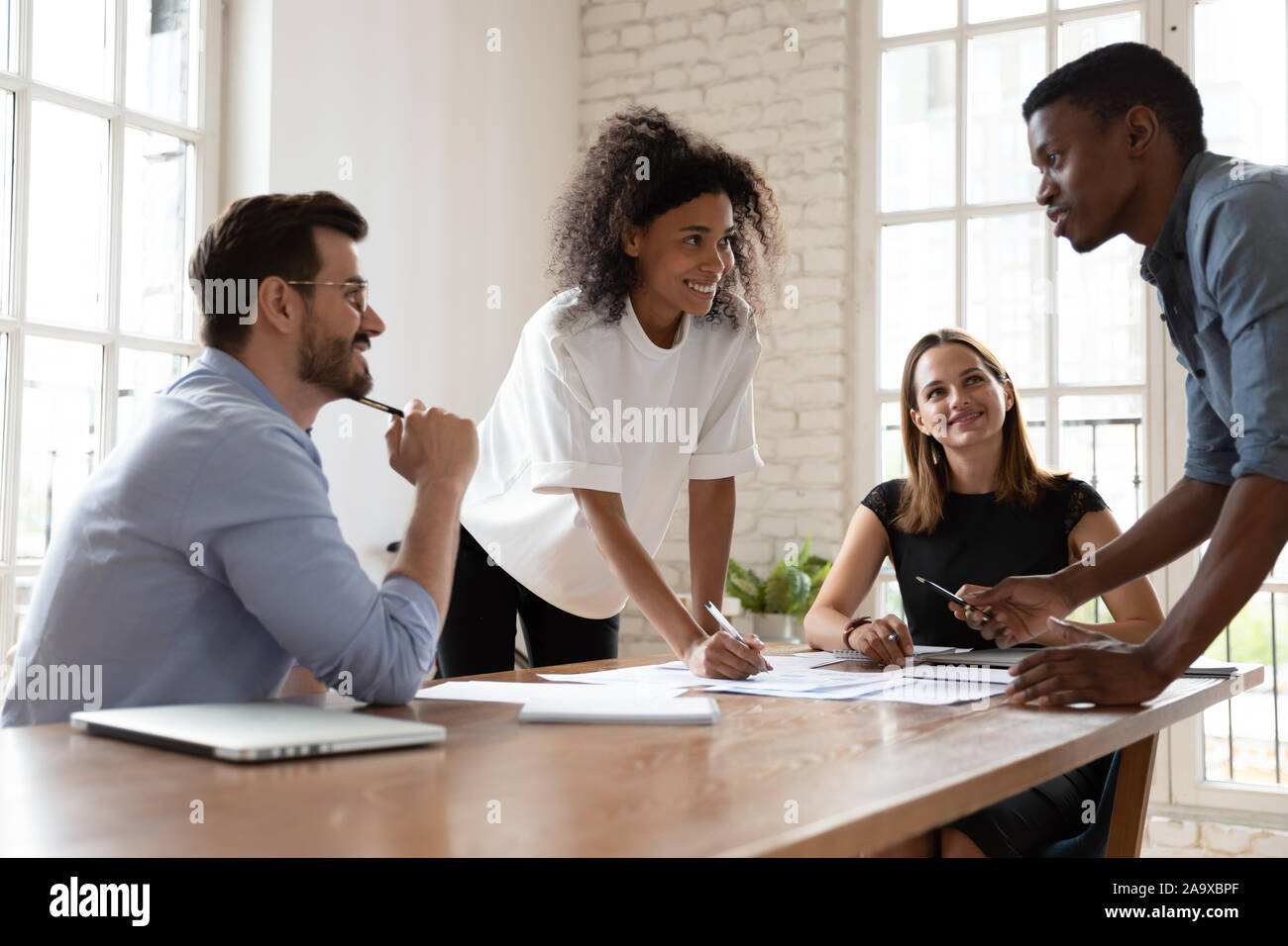 Skilled biracial professional proposing good problem solution. Stock Photo