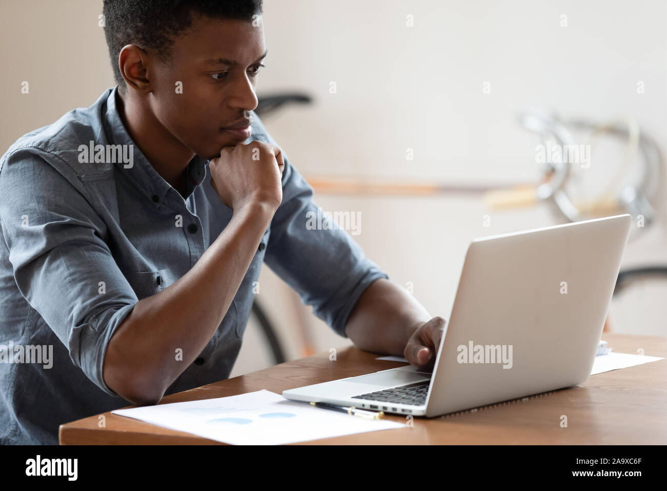 Mixed race business analyst working with marketing statistics. Stock Photo
