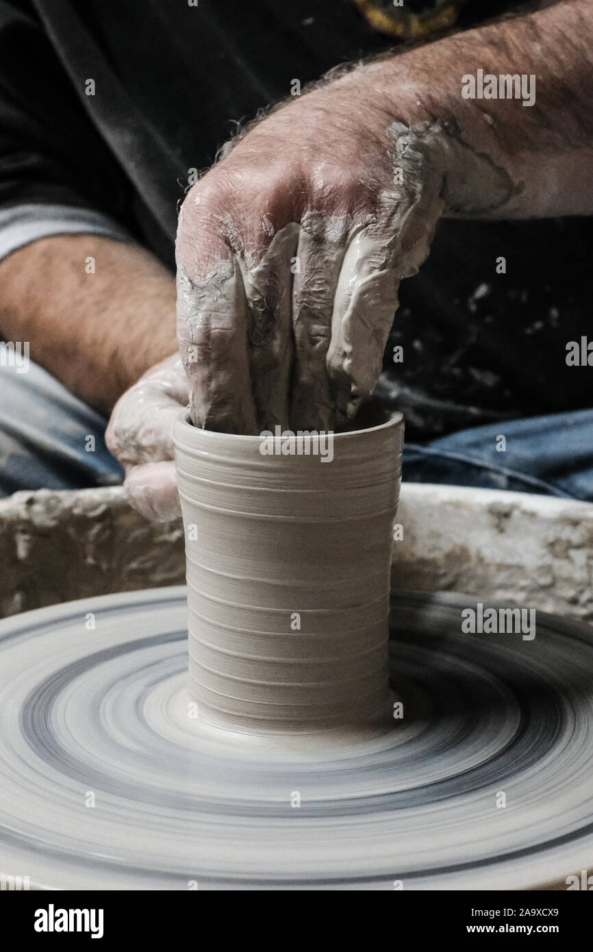 Mitspe Ramon, Israel. 17th November, 2019. A potter crafts a clay vessel on an electric potter's wheel in a studio in Israel's southern town of Mitspe Ramon in the midst of the Negev Desert. Credit: Nir Alon/Alamy Live News. Stock Photo