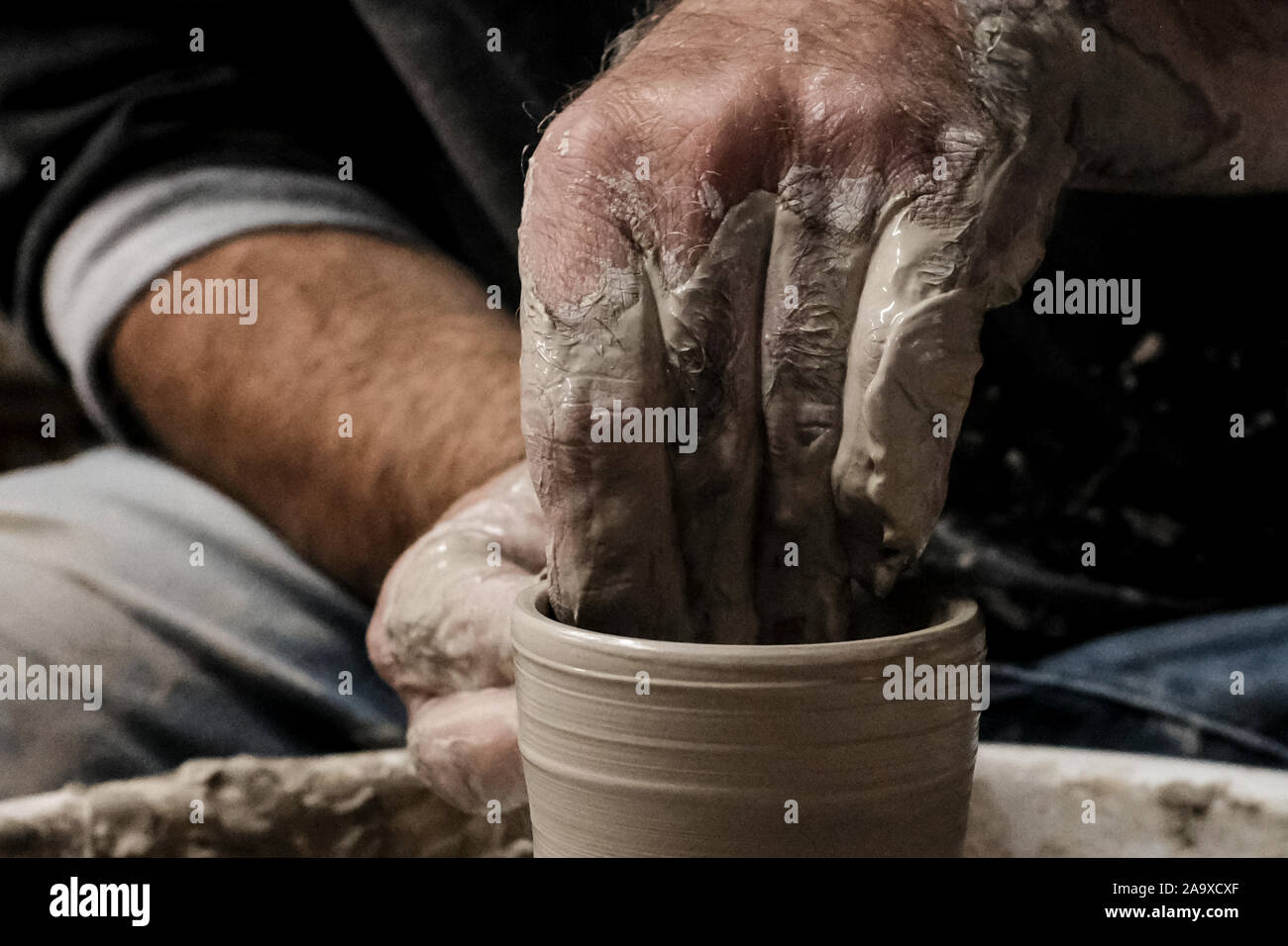 Mitspe Ramon, Israel. 17th November, 2019. A potter crafts a clay vessel on an electric potter's wheel in a studio in Israel's southern town of Mitspe Ramon in the midst of the Negev Desert. Credit: Nir Alon/Alamy Live News. Stock Photo