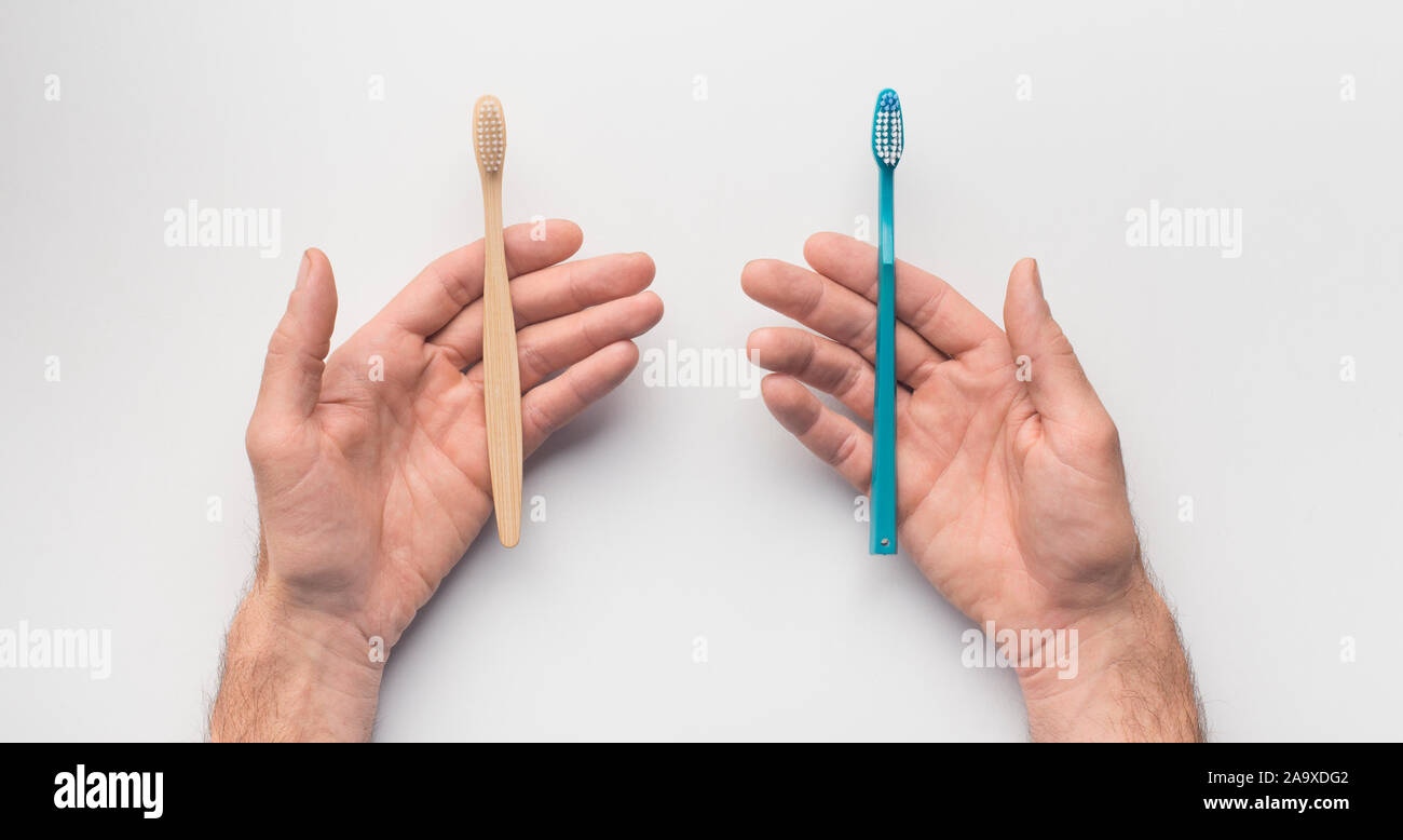 Hands with two toothbrushes on white background Stock Photo