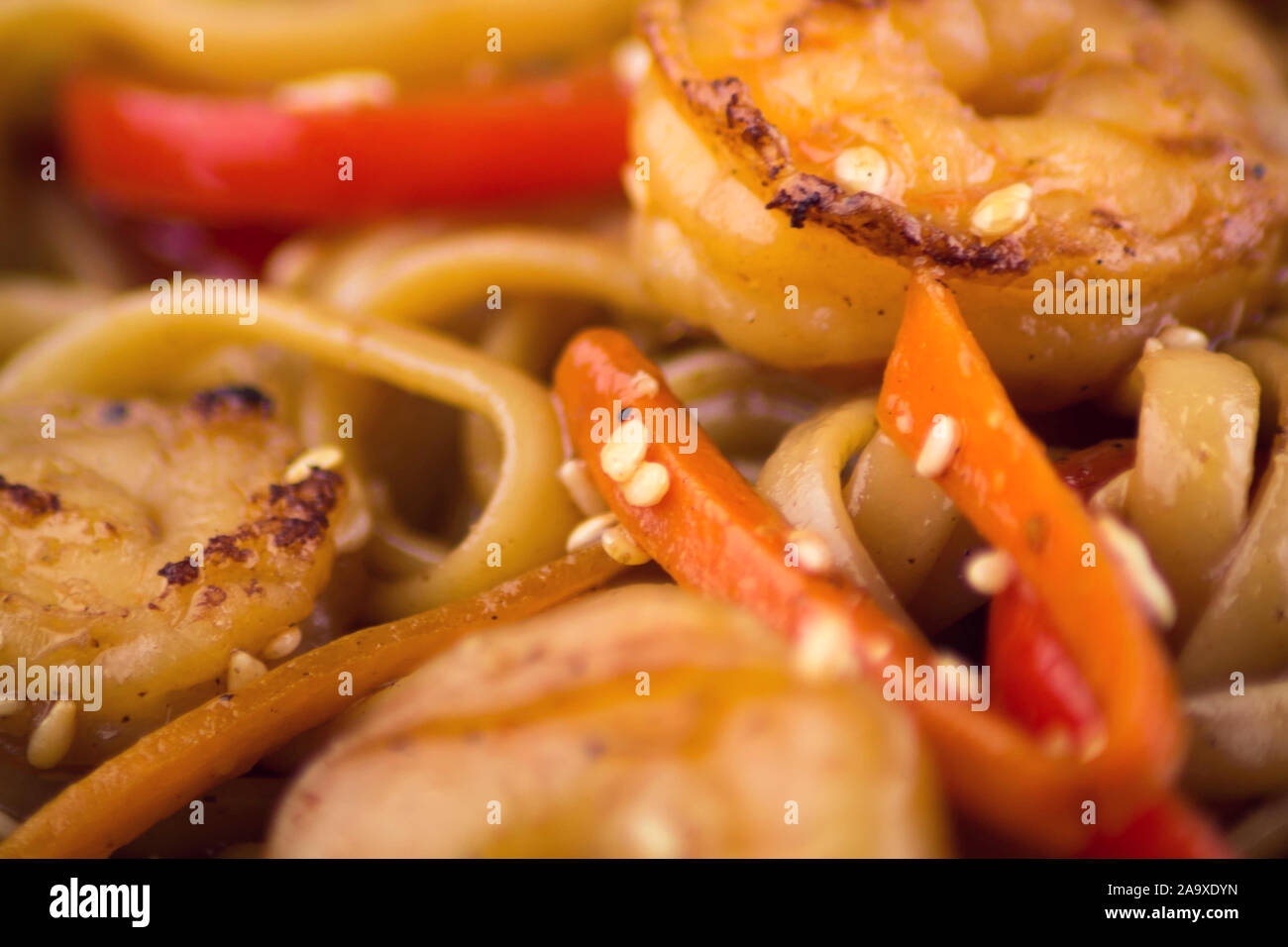 Japanese seafood pasta with shrimps and seasame close up shot. Stock Photo
