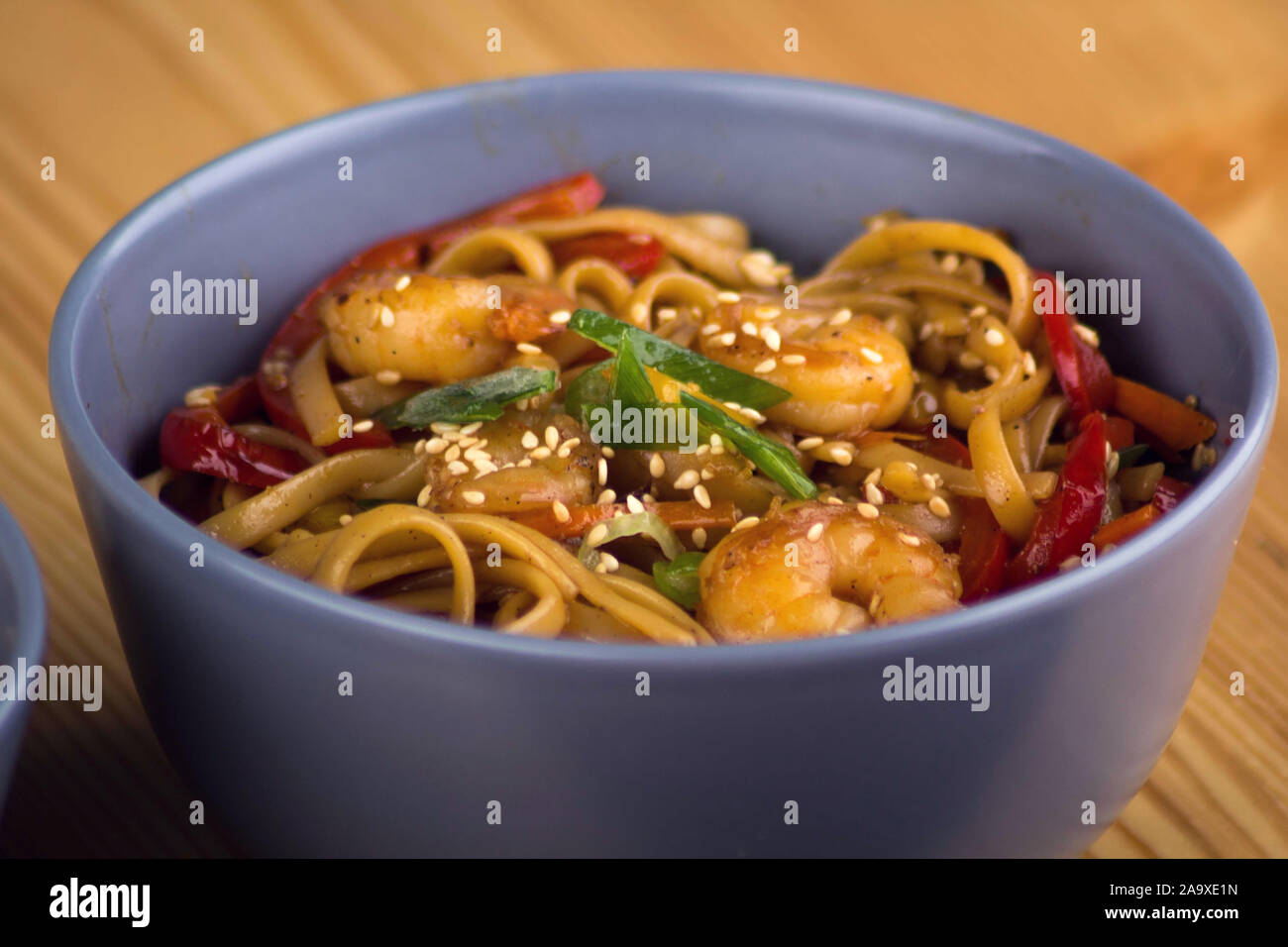 Japanese seafood pasta with shrimps and seasame close up shot. Stock Photo