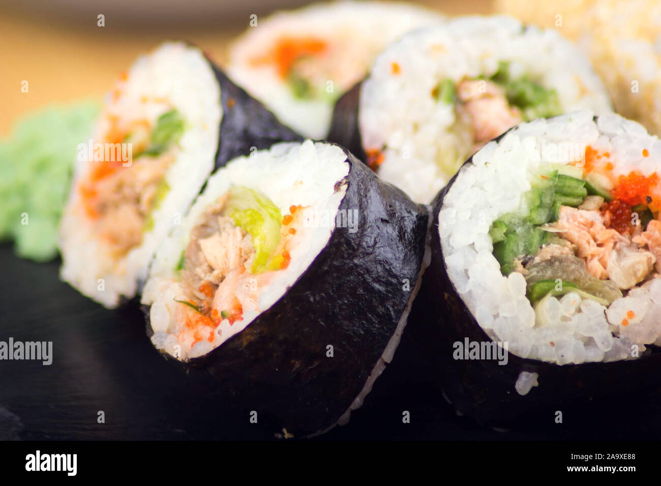 Mix of sushi rolls served on a plate in a restaurant. Japanese food Stock Photo