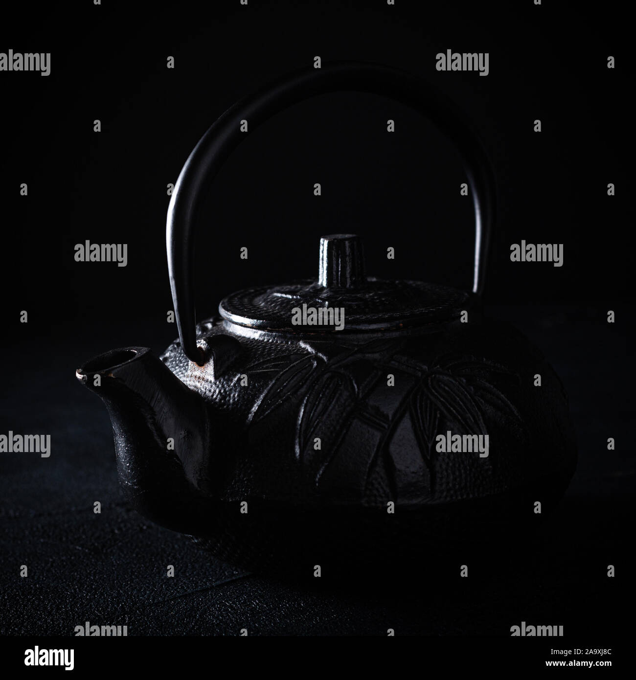 Black iron teapot over dark background Stock Photo Alamy