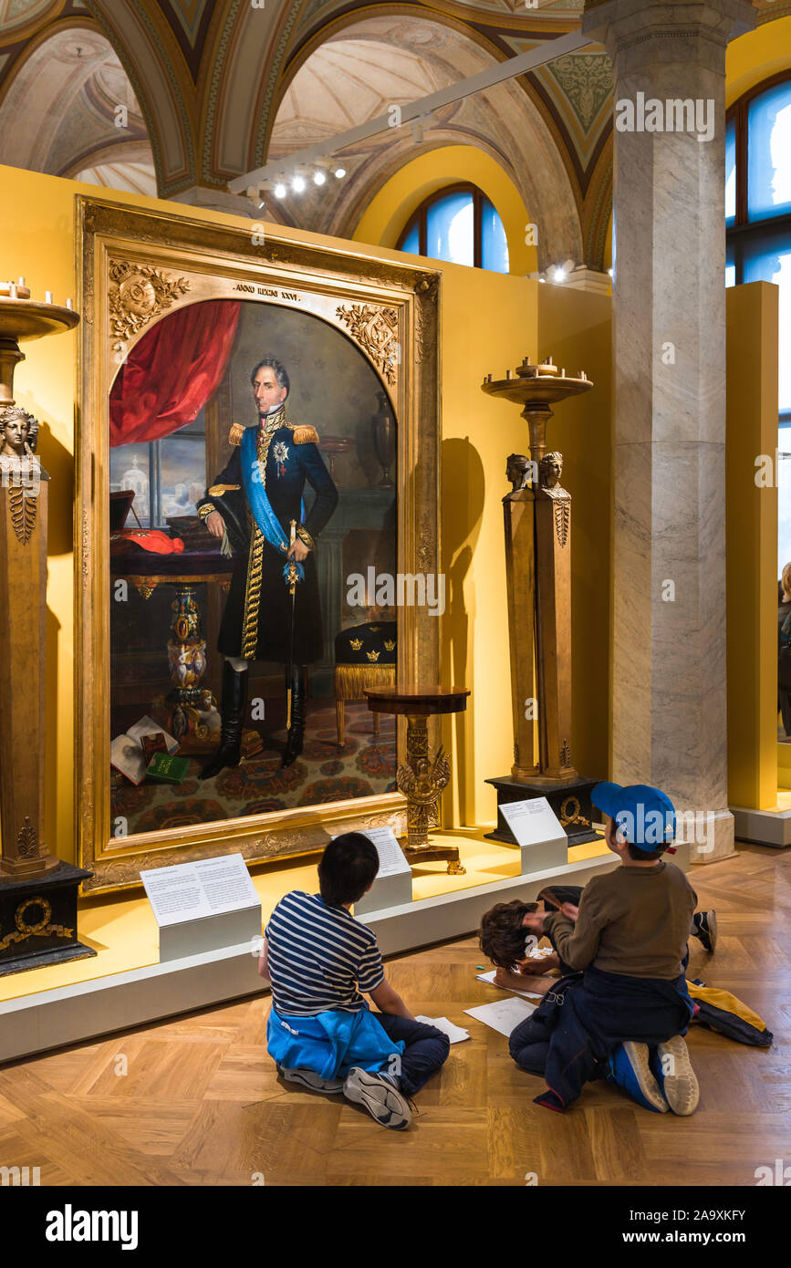 Children art museum,view of a group of school children studying a portrait of Swedish King Karl XIV Johan by Émile Mascré, Nationalmuseum, Stockholm. Stock Photo