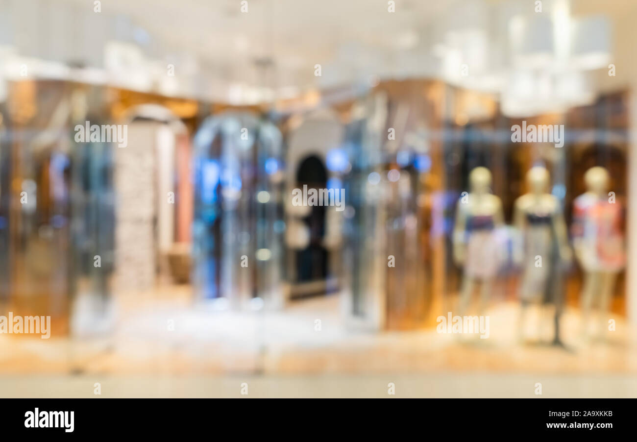 Abstract blurry modern fashion clothes store in a luxury shopping mall ...