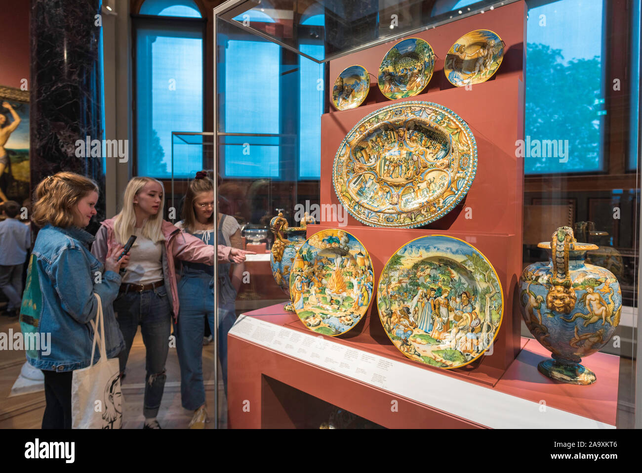 Ceramic majolica, view of young people studying a display of 16th century Urbino majolica tableware on display in the Nationalmuseum, Stockholm Sweden. Stock Photo