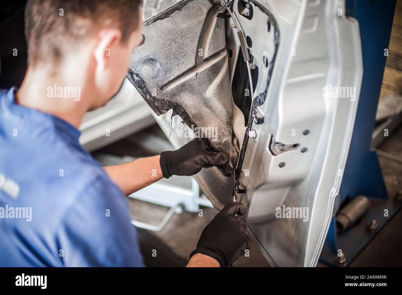 Car Master Mechanic Works On The Interior Of A Car Door At