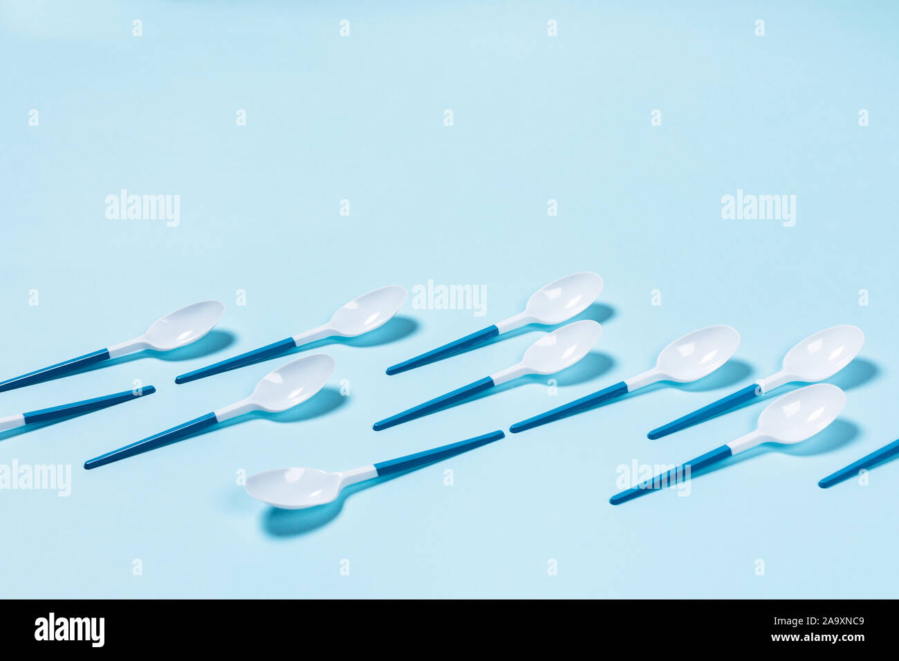 Beautiful and dangerous plastic spoons with blue handles on blue