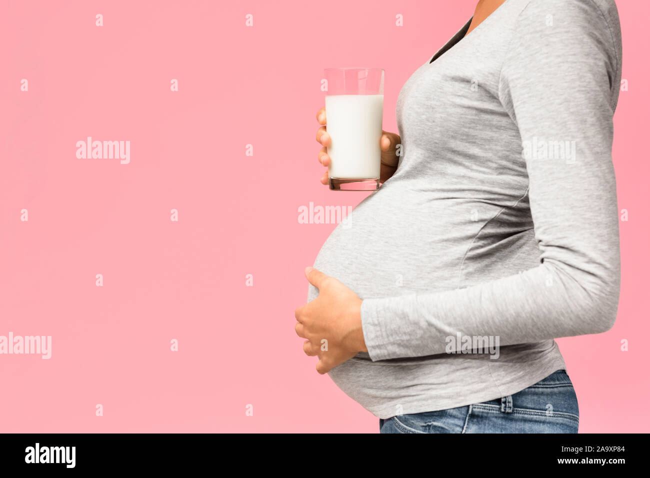 Healthy diet during pregnancy. Lady holding glass of milk Stock Photo