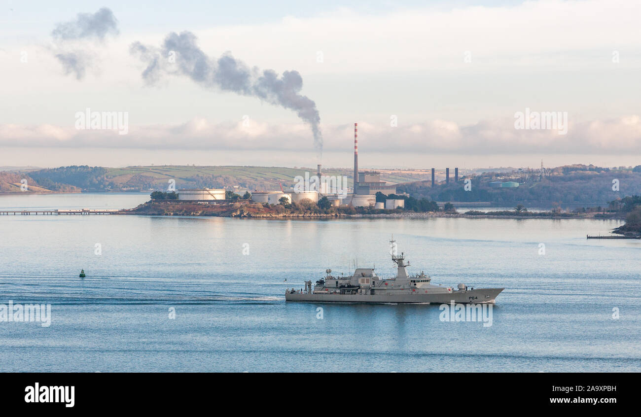 Crosshaven, Cork, Ireland. 18th November, 2019. Irish Naval Ship LÉ George Bernard Shaw passing the ESB generating Station and oil storage tanks  in Aghada as she heads out of the harbour on patrol in Co. Cork, Ireland. Credit; David Creedon / Alamy Live News Stock Photo