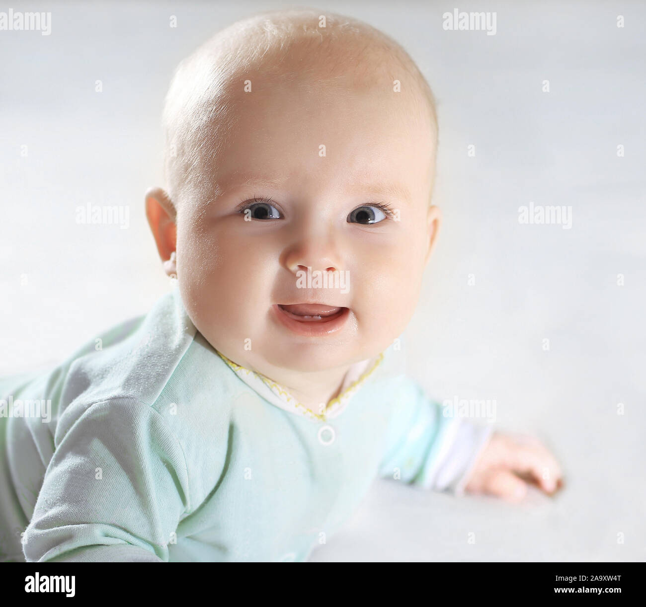 close up.happy a pretty little baby lay on bed.photo with copy s Stock